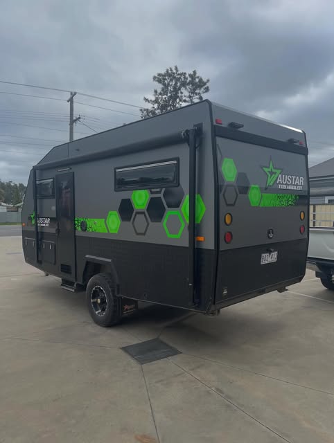 Printed hex-pattern decal kit applied across a touring caravan