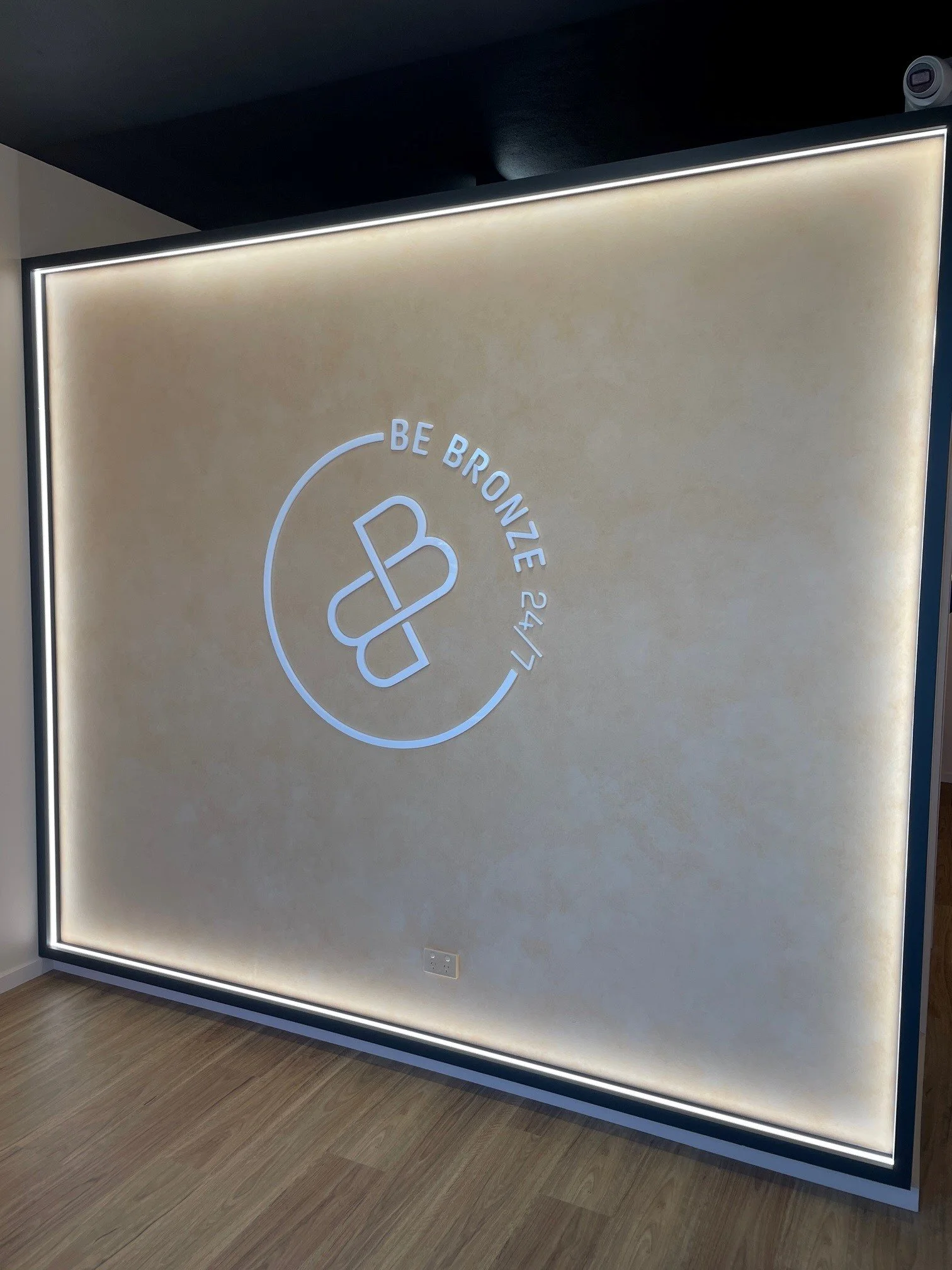 Backlit acrylic reception logo wall for a Wangaratta tanning studio