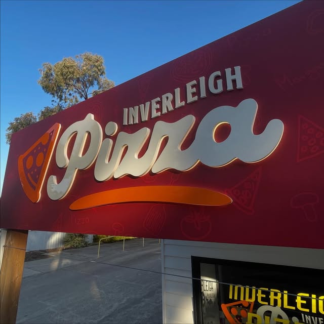 Dimensional shopfront sign with raised script lettering for a pizza shop
