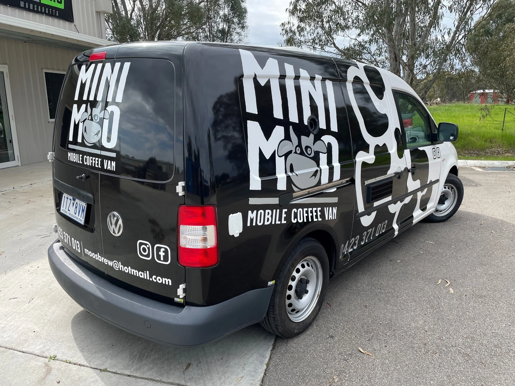 Full cow-print vehicle wrap on a mobile coffee van