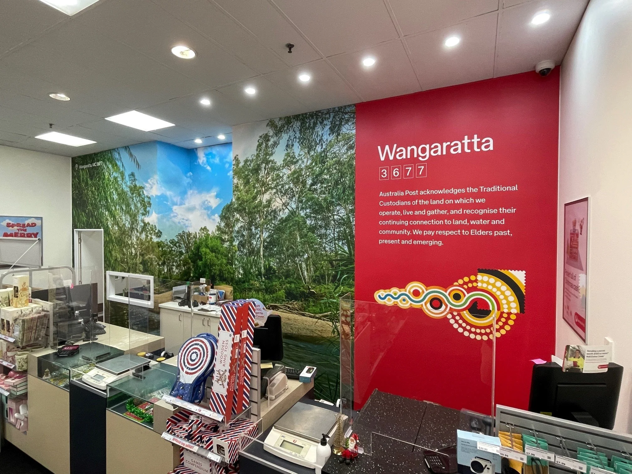 Full-height printed river-scene wall mural inside Australia Post Wangaratta