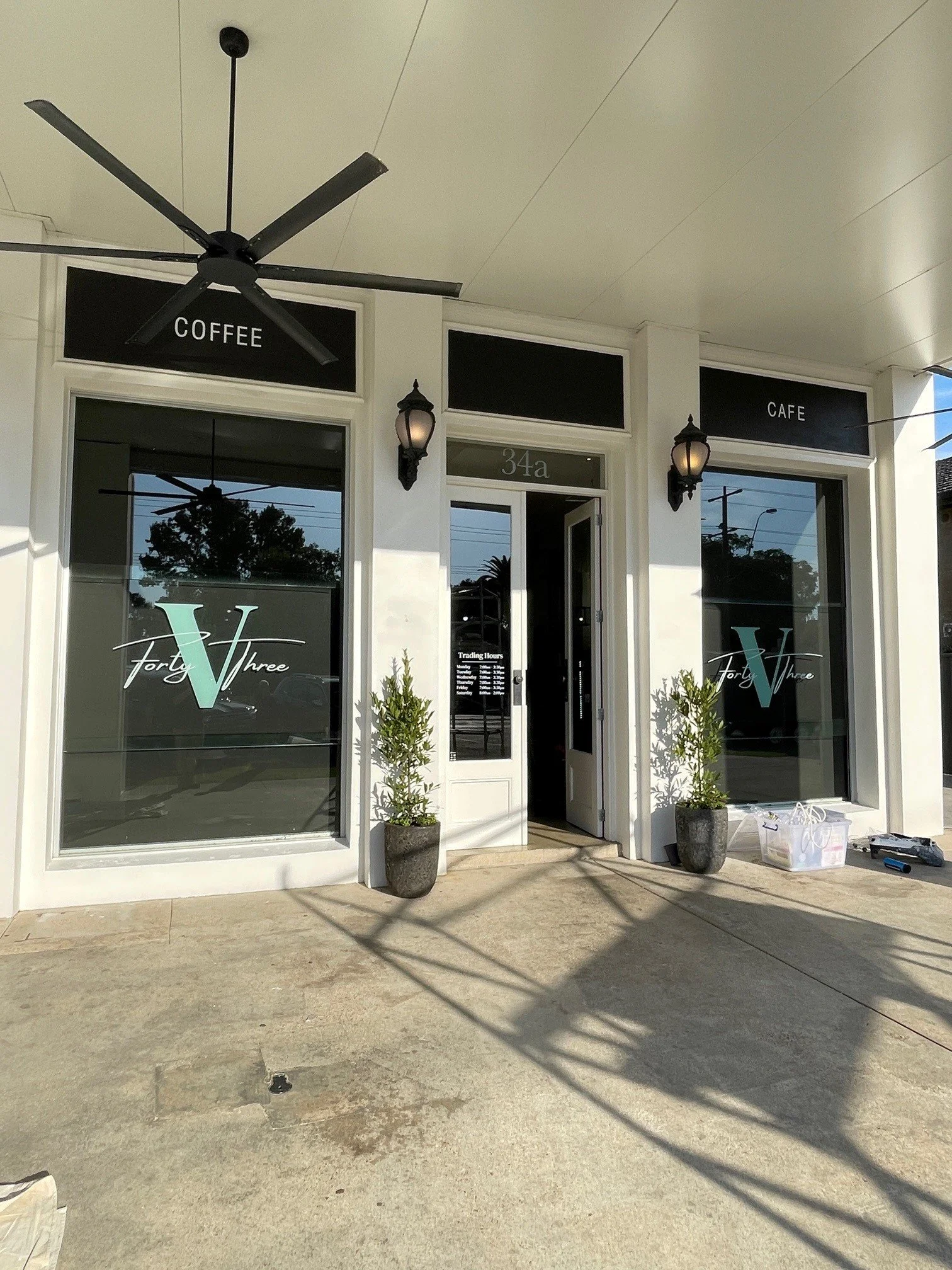 Logo window decals on a heritage-style cafe shopfront